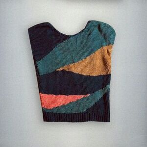 Multi color stitch sleeveless sweater with low back. Cropped length.